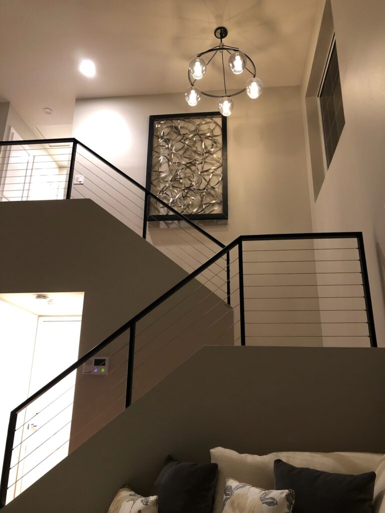 Installed Modern Light Fixture in a Tall 2-Story Home